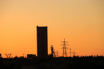Mine tower silhouette at sunrise or sunset