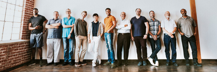 Cheerful diverse men standing in a row - Powered by Adobe
