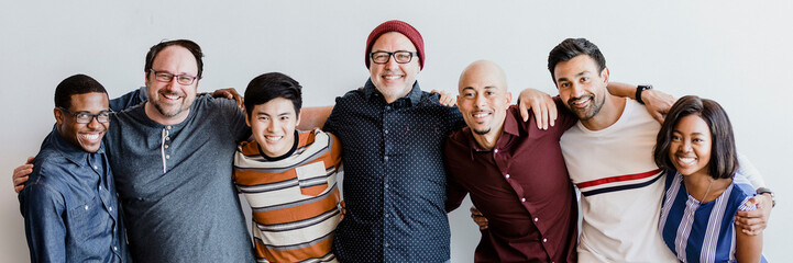 Cheerful diverse people embracing each other