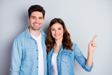 Fototapeta na wymiar Photo two people attractive lady handsome guy direct finger side empty space advising cool offer sale shopping store wear casual denim shirts outfit isolated grey color background