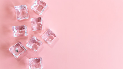 Ice cubes on pink background, Cubes of ice on a light pink background, Flat lay, top view, with copy space and field for text.