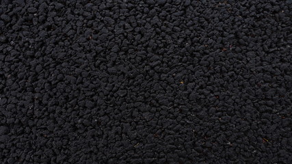 Fresh asphalt. Black structural background