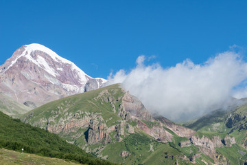 spectacular view of magnificent  kazbek mountain with snow peak in caucasus in geogria. breathtaking view, traveling in beautiful places