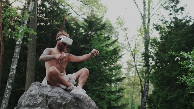 Using Virtual Reality Goggles. Prehistoric Aboriginal Gesturing with Game Controllers. VR Gaming Applications with Cyberspace and Immersive Effect. Technology Developing, Entertainment, Digitalisation