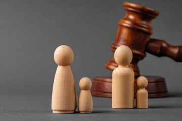 Wooden toy family and judge mallet. Family divorce concept