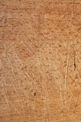 Brown wood texture with scratches. Natural surface of the working space. cracked and friable. macro photo. vertical shot.