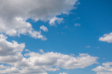 Naklejka na ściany i meble White clouds on a blue sky. Beautiful natural background.