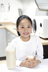Girl holding a glass of milk