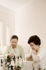 Women playing chess game