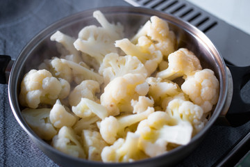 cauliflower inflorescences are cooked in a pan, tasty healthy vegetable food,