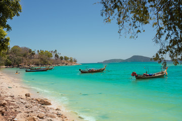 Fototapeta na wymiar exotic islands. Boats stand in azure water near the shore. Phuket, Thailand