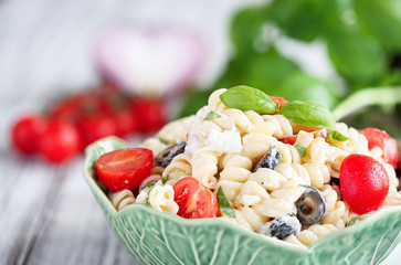 Pasta Salad with freshly chopped basil, tomatoes, black olives, red onion and Feta cheese, tossed with an Italian oil dressing. 