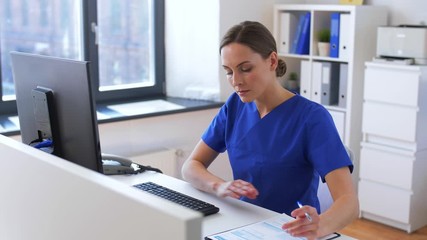 medicine, technology and healthcare concept - female doctor or nurse with computer and medical report working at hospital - Powered by Adobe