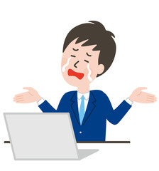 パソコンの前でお手上げポーズをするネクタイの男性