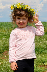 Cute Little Girl with Wreath in the Summer 