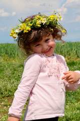 Cute Little Girl with Wreath in the Summer 