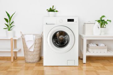 Rustic interior of home laundry room with modern washing machine - obrazy, fototapety, plakaty