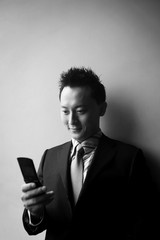 Businessman text messaging on the mobile phone