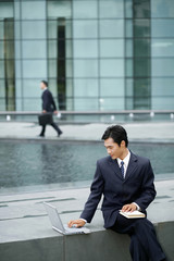 Businessman smiling while using laptop