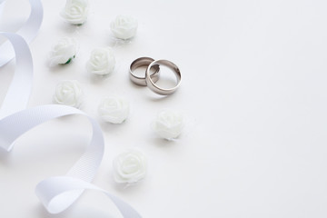 Wedding rings are decorated with a ribbon with copy space. Concept backgrounds for weddings.