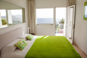 Interior design in bedroom of pool villa with cozy king bed. Bedroom with green and white colors