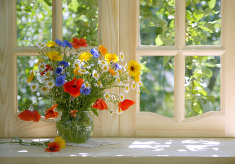 still life with a bright summer bouquet on a sunlit windowsill