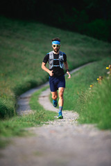 Man with beard athlete running in the mountains during a workout