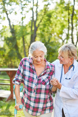 Caregiver helps senior citizen during running training