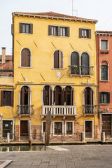 Fototapeta na wymiar Venice downtown, close-up of old houses in front of a canal of the Venetian lagoon. UNESCO world heritage site, Veneto, Italy, Europe