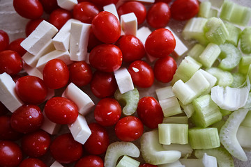 A simple salad for a healthy diet. Cherry tomatoes, celery and slices of cheese. Fresh vegetables for a vitamin diet.