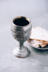 Jesish kiddush wine cup for passover with matzot, matzo bread. Pesah holiday. Banner with copy...