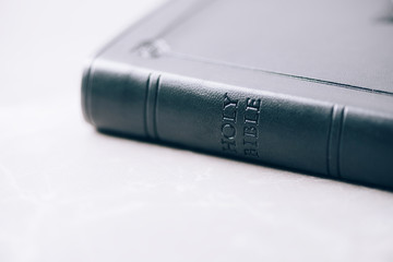 Holy Bible over stone background. Copy space. Symbol of christianity