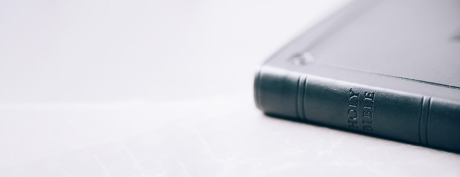 Holy Bible over stone background. Copy space. Symbol of christianity