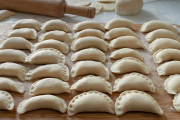 Dumplings raw on a wooden board 