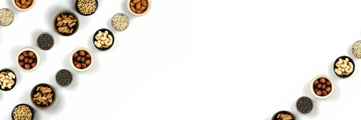 Poster for an inscription with nuts in beautiful cups located diagonally on an isolated background. Top view, close up.