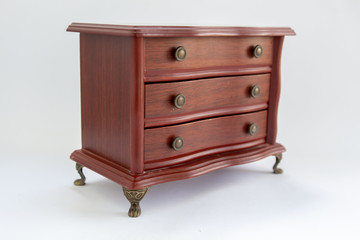 wooden chest of drawers on a white background