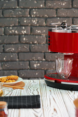 Red coffee machine with a glass on kitchen counter