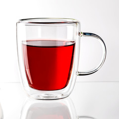 Pomegranate juice in a Cup on a white background.