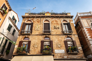 Venice, ancient house with bas reliefs in Campiello de l’Anconeta (Campiello is a small town square). UNESCO world heritage site, Veneto, Italy, Europe