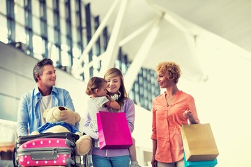 Family on holiday trip walking in airport
