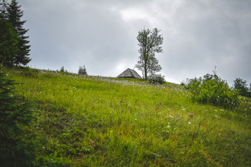 mountain landscape with hut and massive clouds