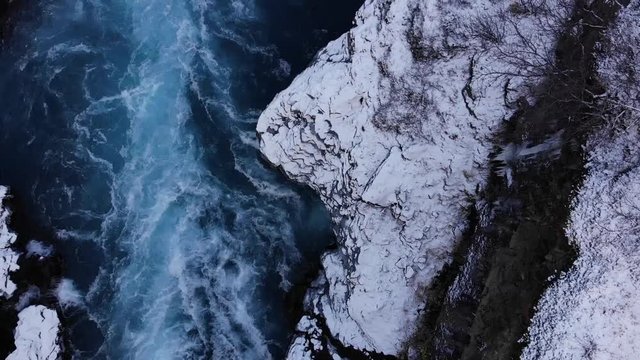 A drone with cinematic movements shows the beautiful Icelandic waterfall 
