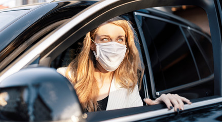 Business woman is using car transportation while working on phone