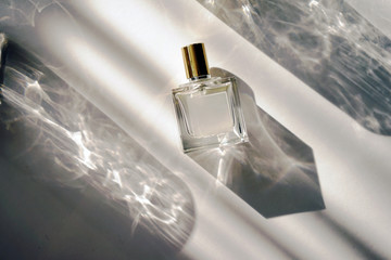 glass perfume bottle with beautiful shades from the window
