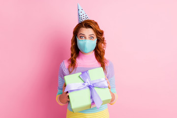 Photo of pretty funny lady keep social distance celebrating birthday alone got delivery unknown giftbox present excited wear protect face mask sweater isolated pink color background