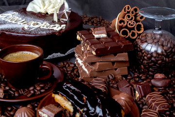 Still-life. Chocolate. Candies. Chocolate cake. Cinnamon. Coffee.