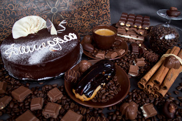 Still-life. Chocolate. Candies. Chocolate cake. Cinnamon. Coffee.