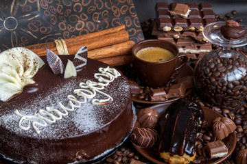 Still-life. Chocolate. Candies. Chocolate cake. Cinnamon. Coffee.