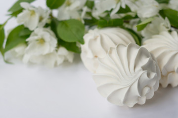 Delicate apple marshmallows decorated with a beautiful flowering branch