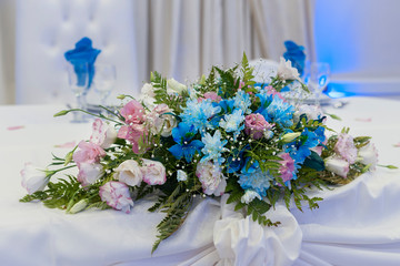 
floral decoration on table in party room for an event, decoration centerpieces with natural flowers
